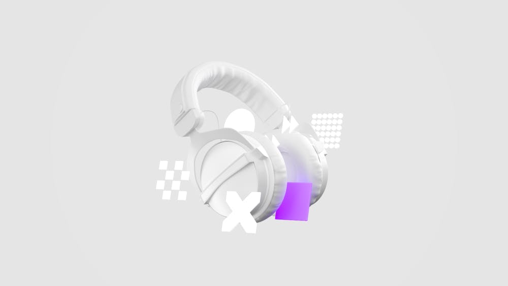 White studio headphones with abstract geometric shapes and a purple cube on a light gray background