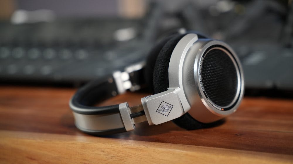 Neumann NDH 30 headphones side view showing logo branding and aluminum construction in studio setup