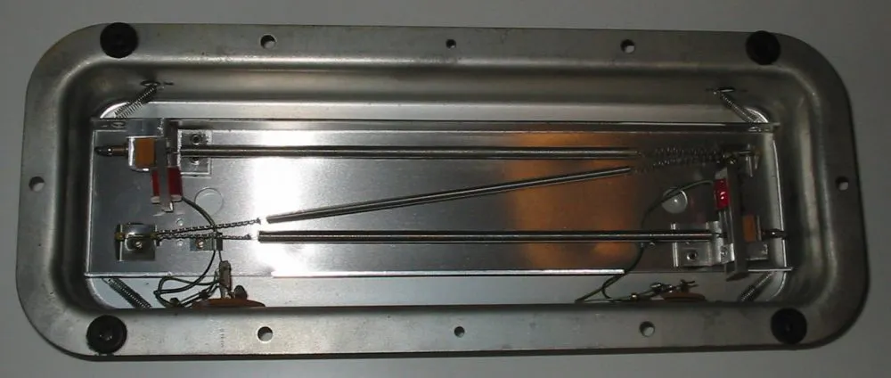 Internal mechanism of a spring reverb unit showing tensioned metal springs used to simulate reverberation as a delay-based effect
